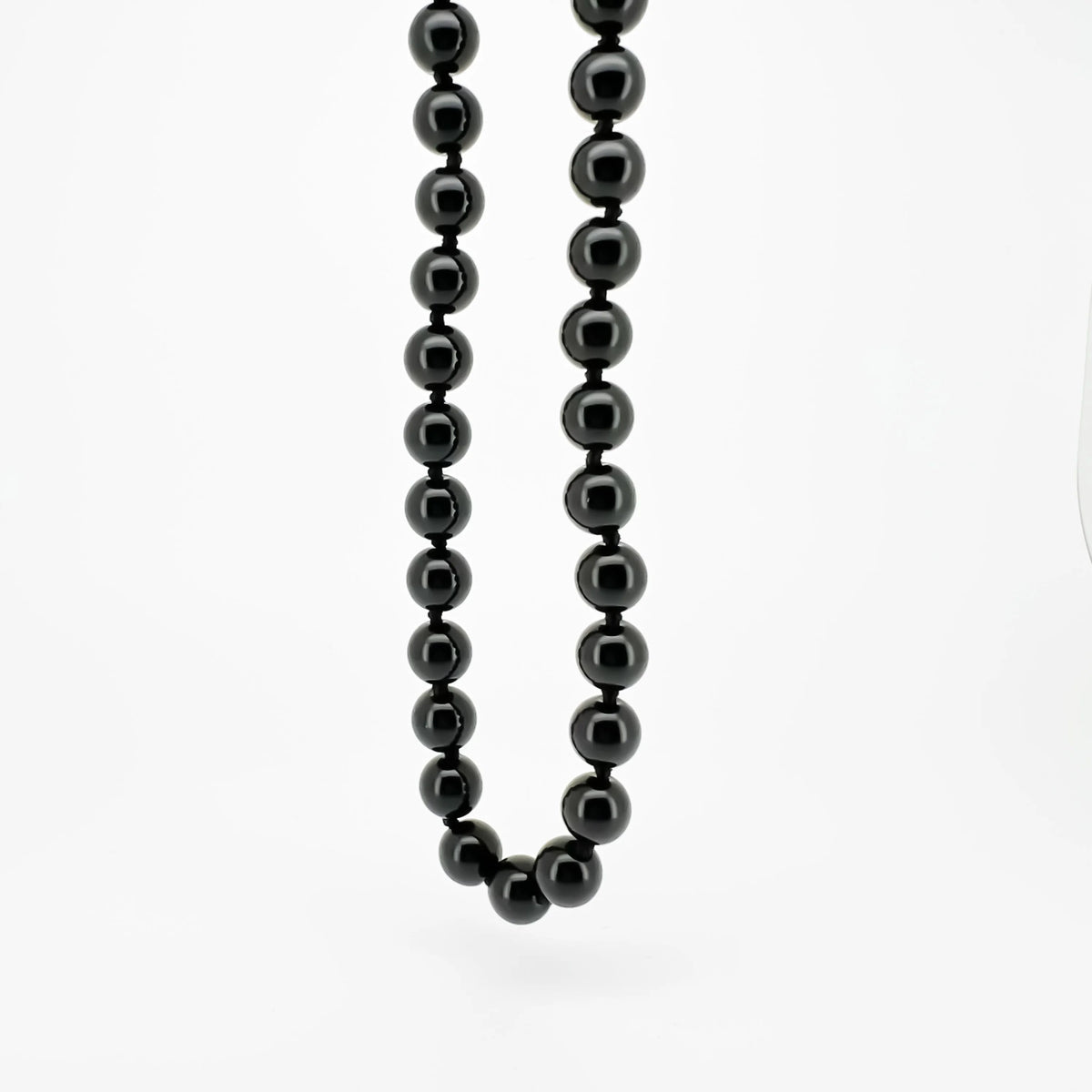 Necklace made of shiny black beads strung together.