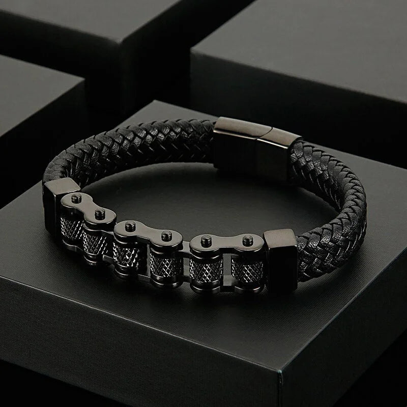 Black leather and metal bracelet with a chain-like design element.