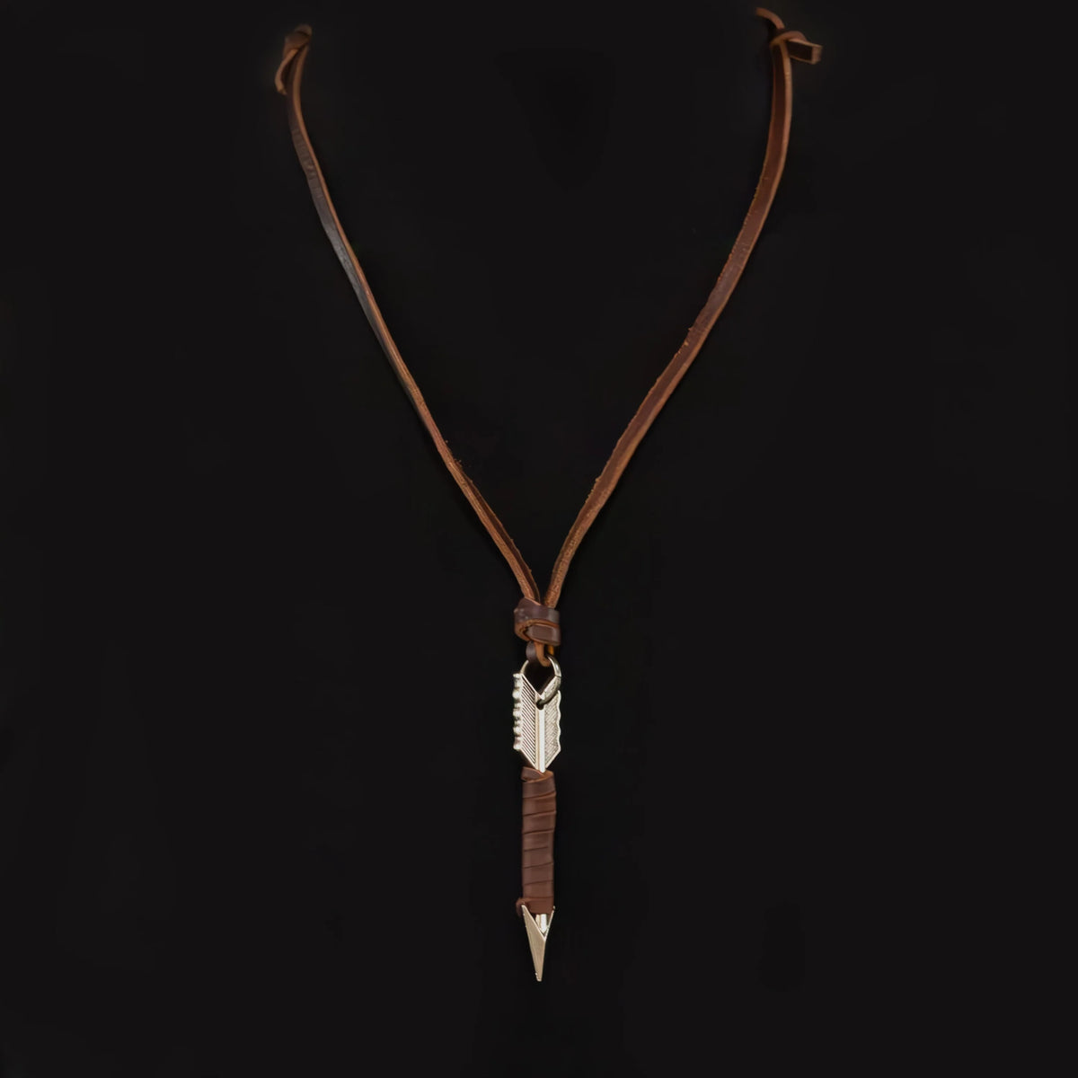 Leather necklace with a silver arrow-shaped pendant.