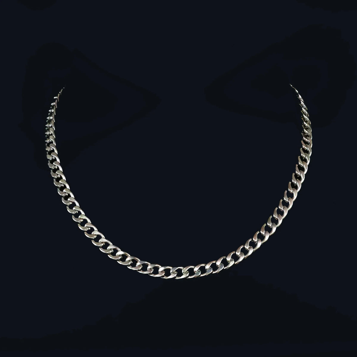 Silver chain necklace with interlocking curved links.