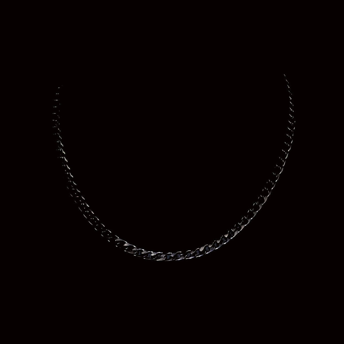 Silver or metallic chain necklace against a black background.