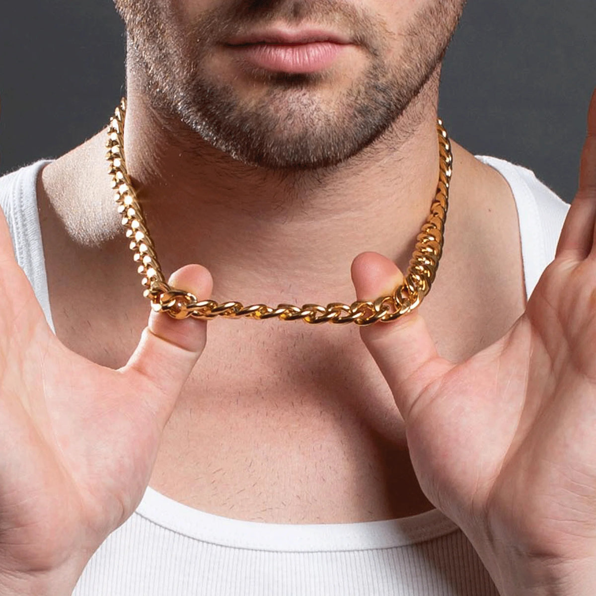 Gold chain necklace worn around a person’s neck.