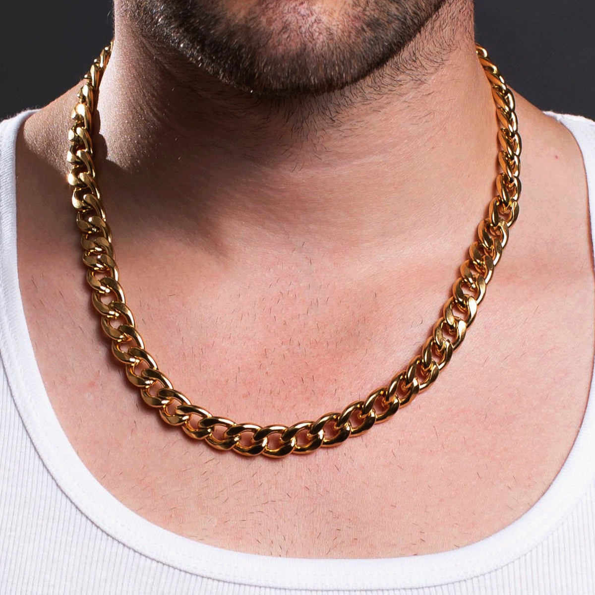 Gold chain necklace worn around a person’s neck.