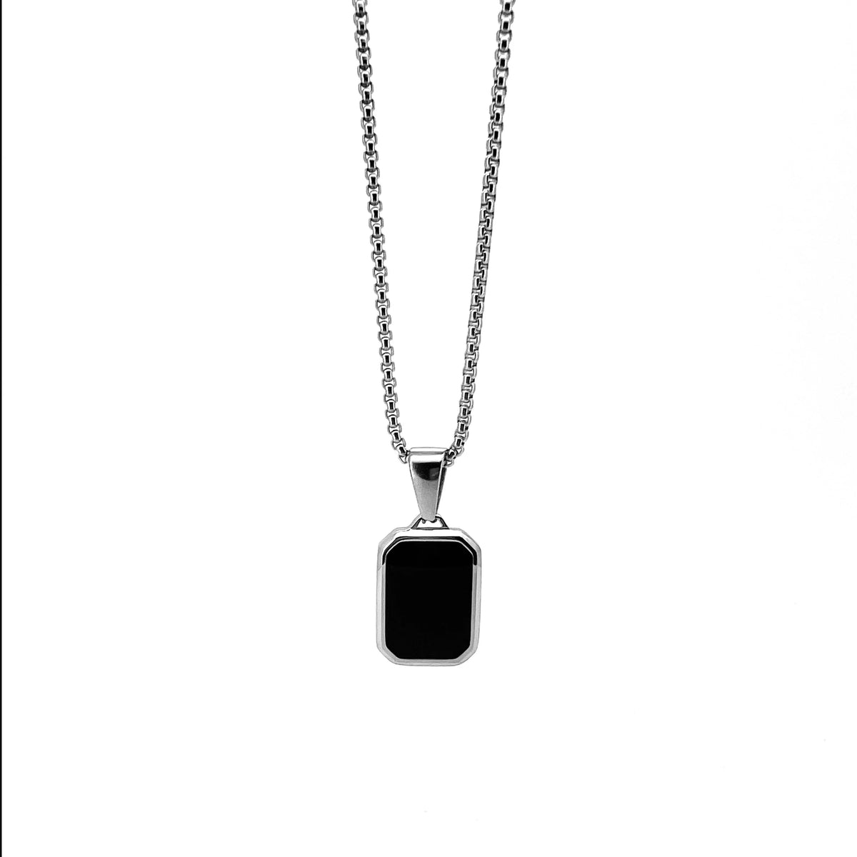 Silver necklace with a rectangular black pendant.