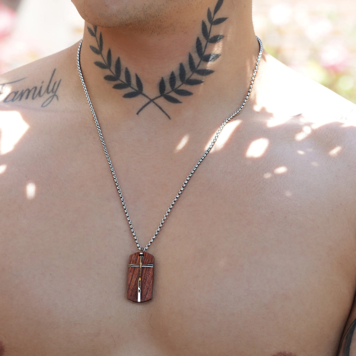 Silver chain necklace with a cross pendant.