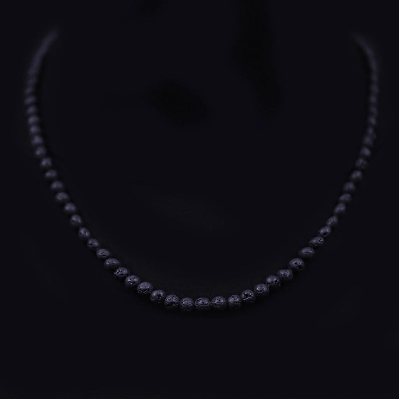 Diamond necklace with graduated stones set in a dark metal.