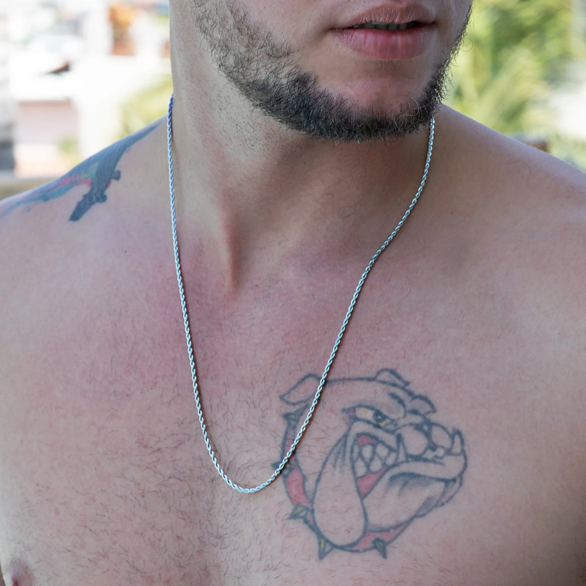 Tattoo of a bulldog’s face on a person’s chest.