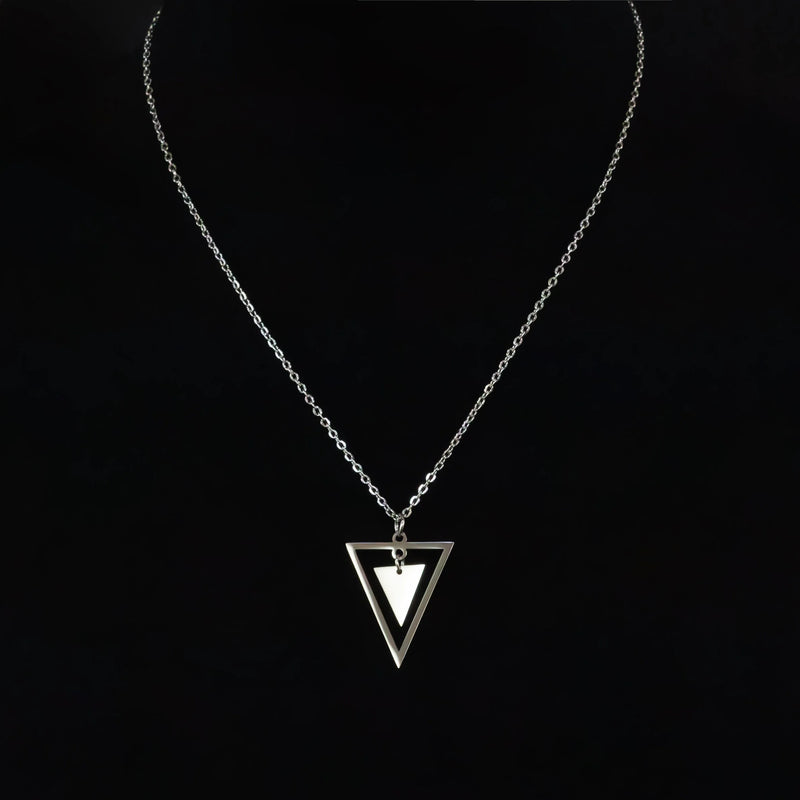 Silver necklace with a triangular pendant featuring nested triangles.