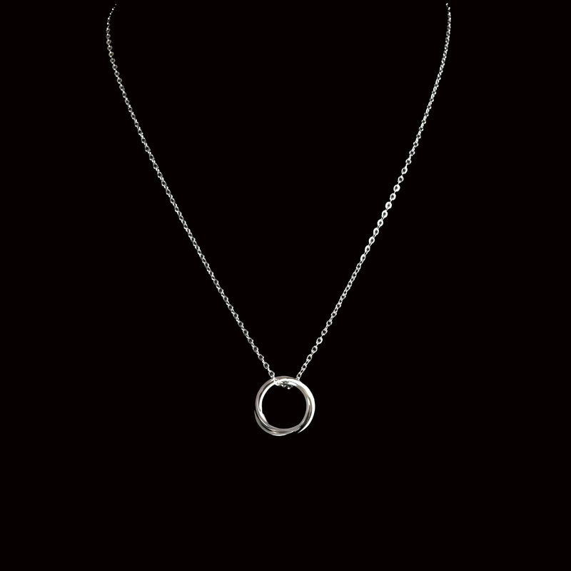 Silver necklace with a circular pendant.