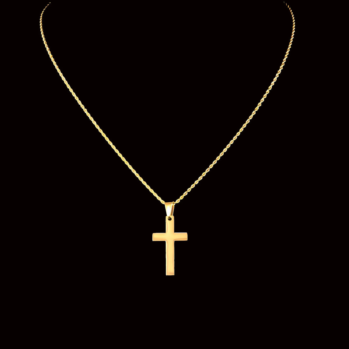 Gold cross pendant necklace on a thin chain.