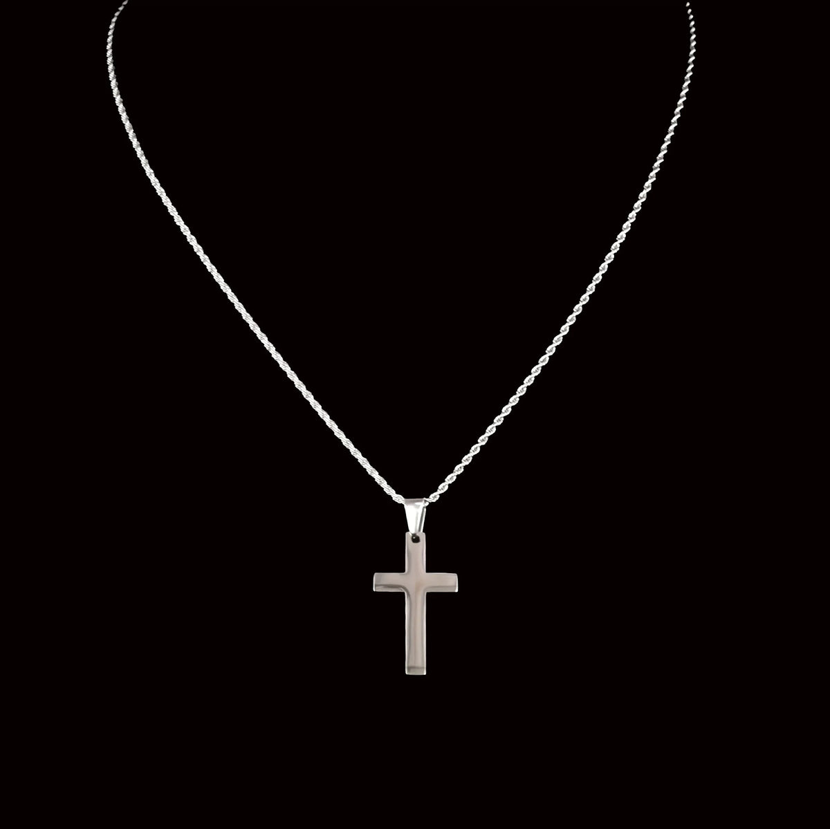 Silver cross pendant necklace on a thin chain.