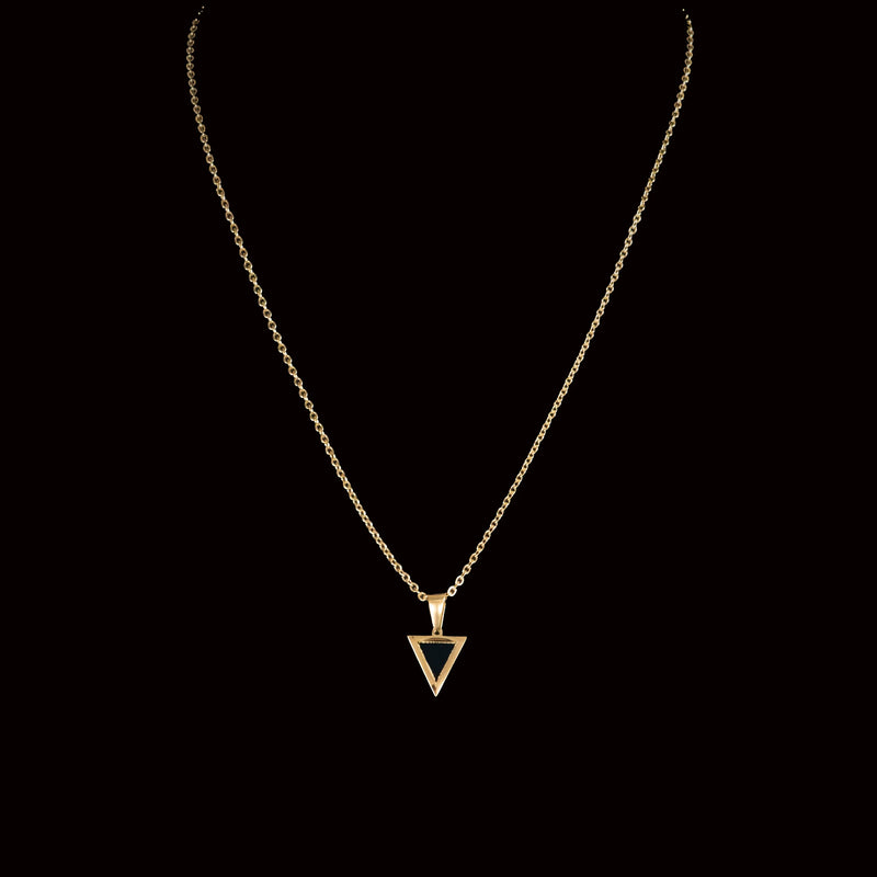 Gold necklace with a triangular pendant.