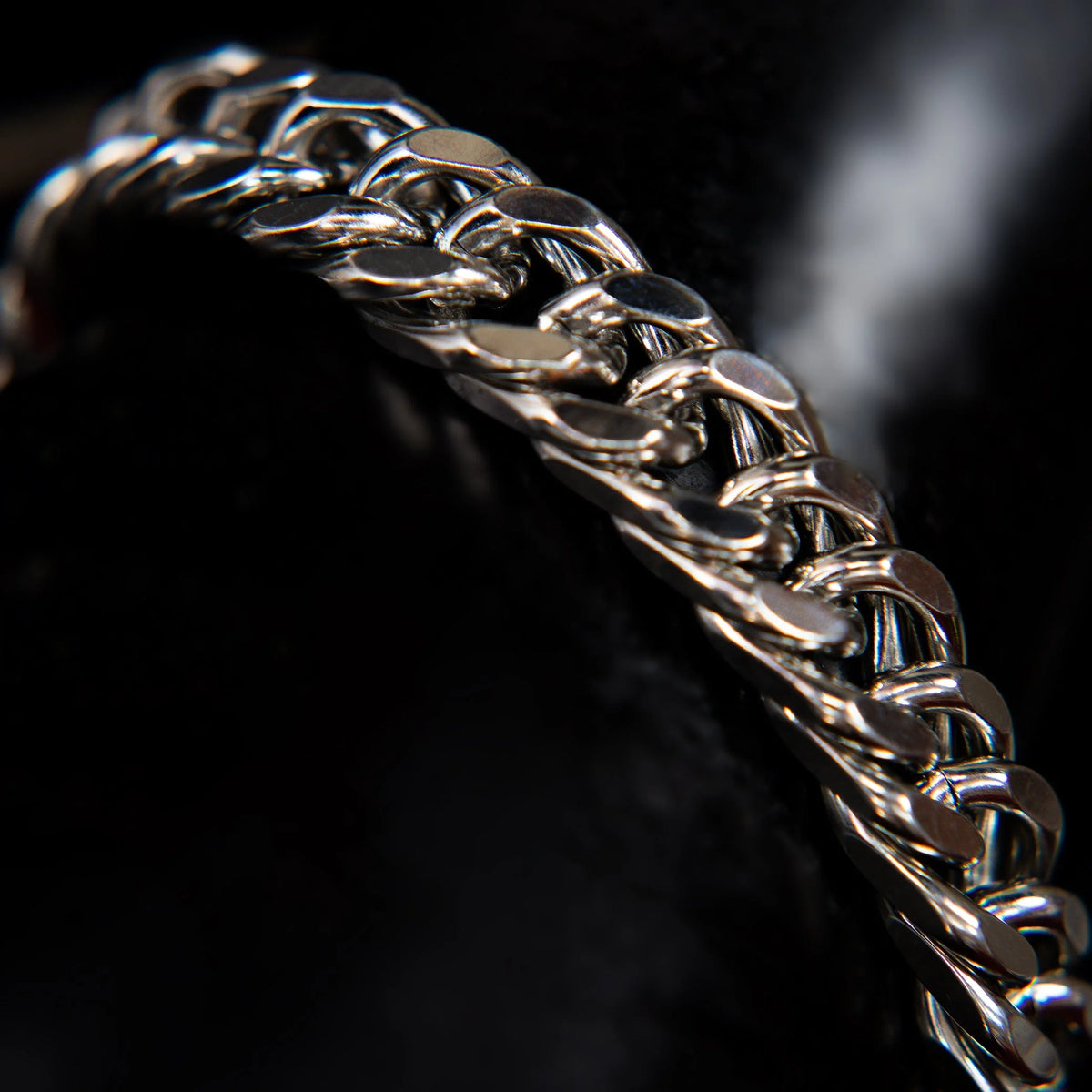 Shiny silver chain bracelet with interlocking links.