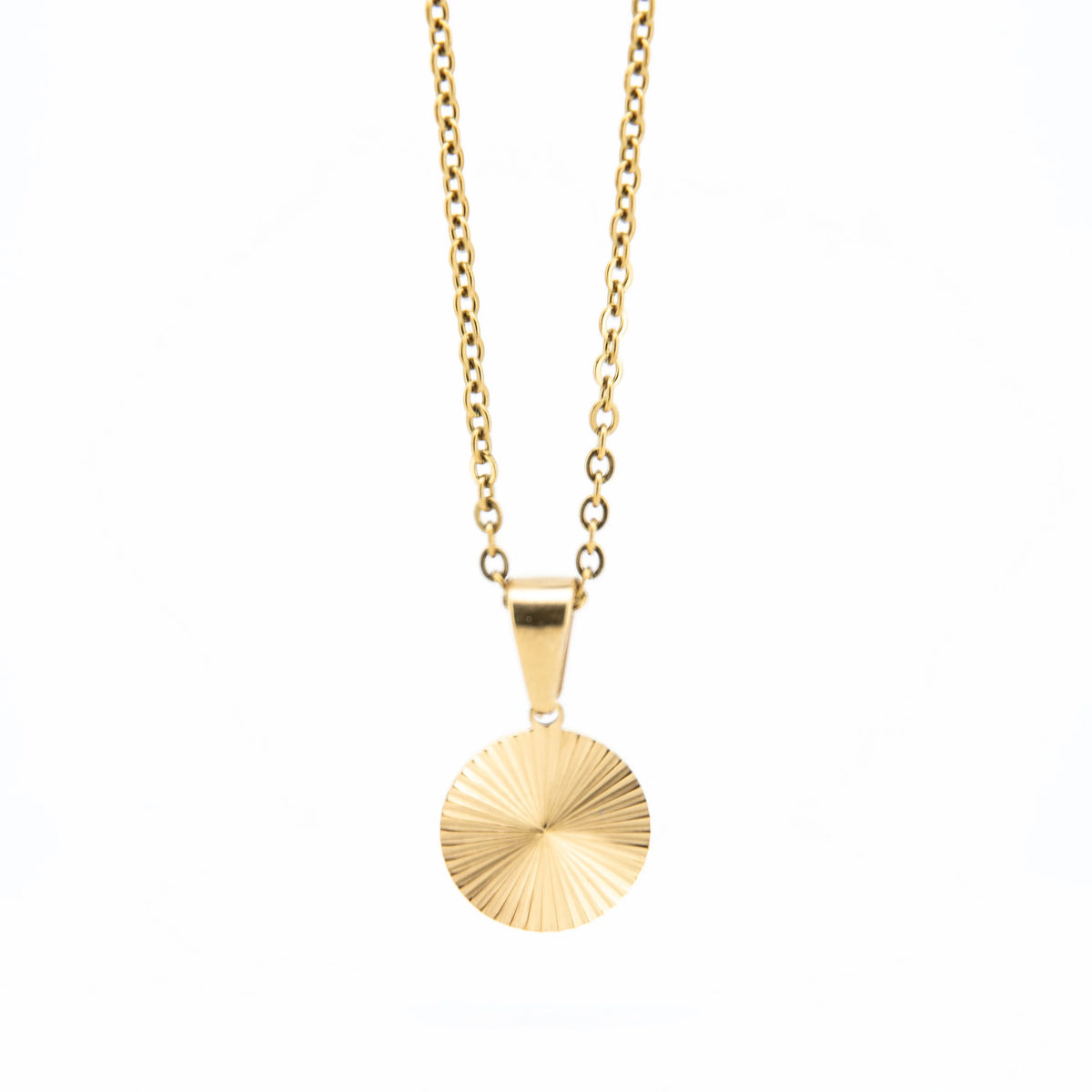 Gold pendant necklace with a circular, sunburst-patterned charm.