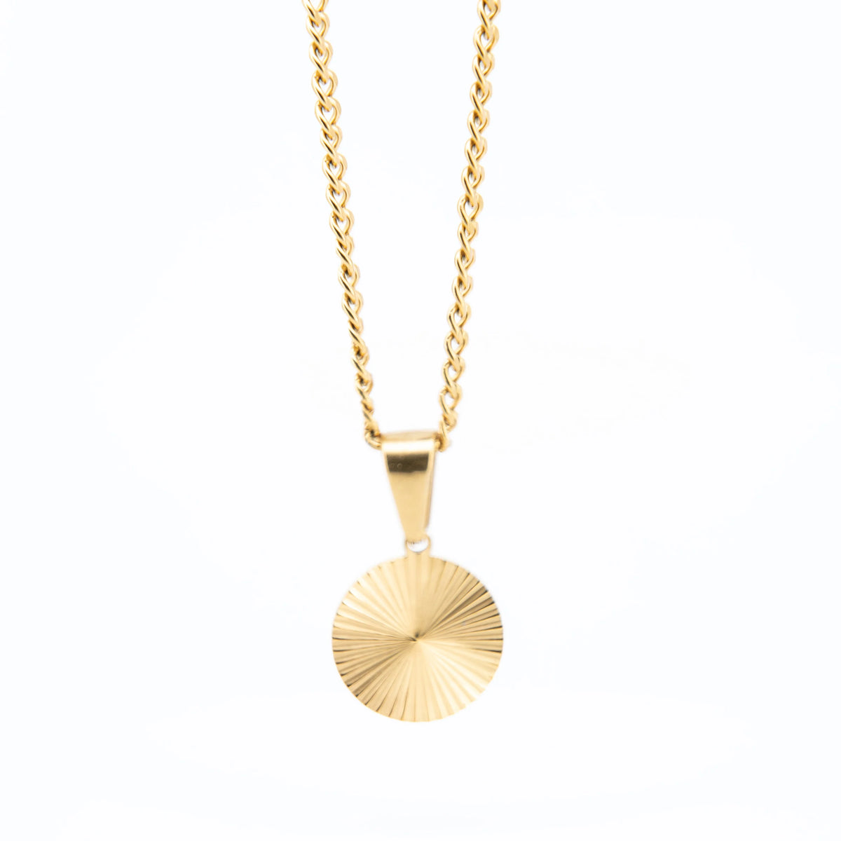 Gold necklace with a circular sunburst pendant.