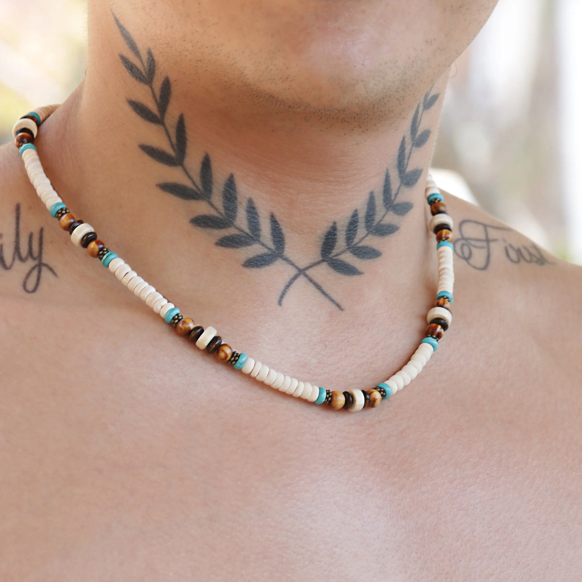 Beaded necklace with white, brown, and turquoise colored beads.