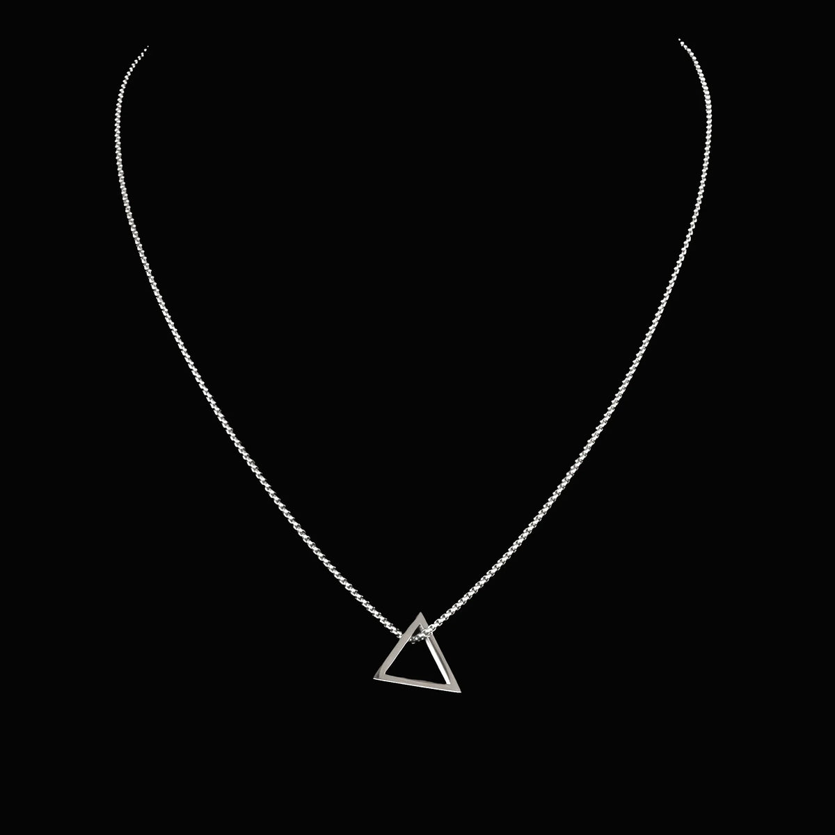 Silver necklace with a triangular pendant.