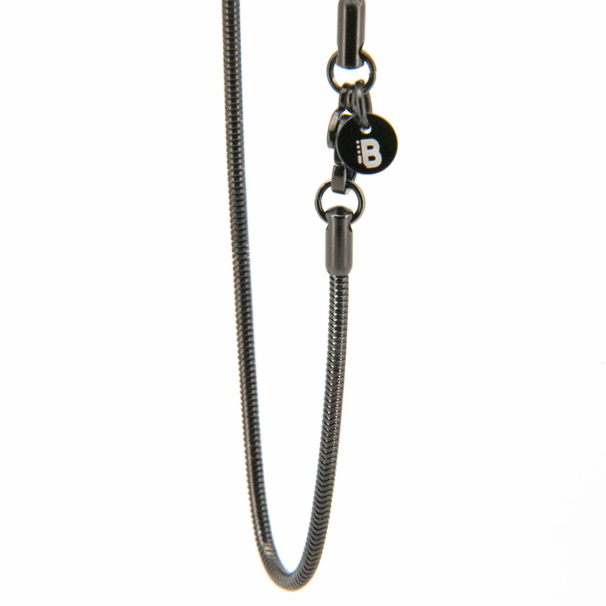 Metallic snake chain necklace with a small black charm attachment.