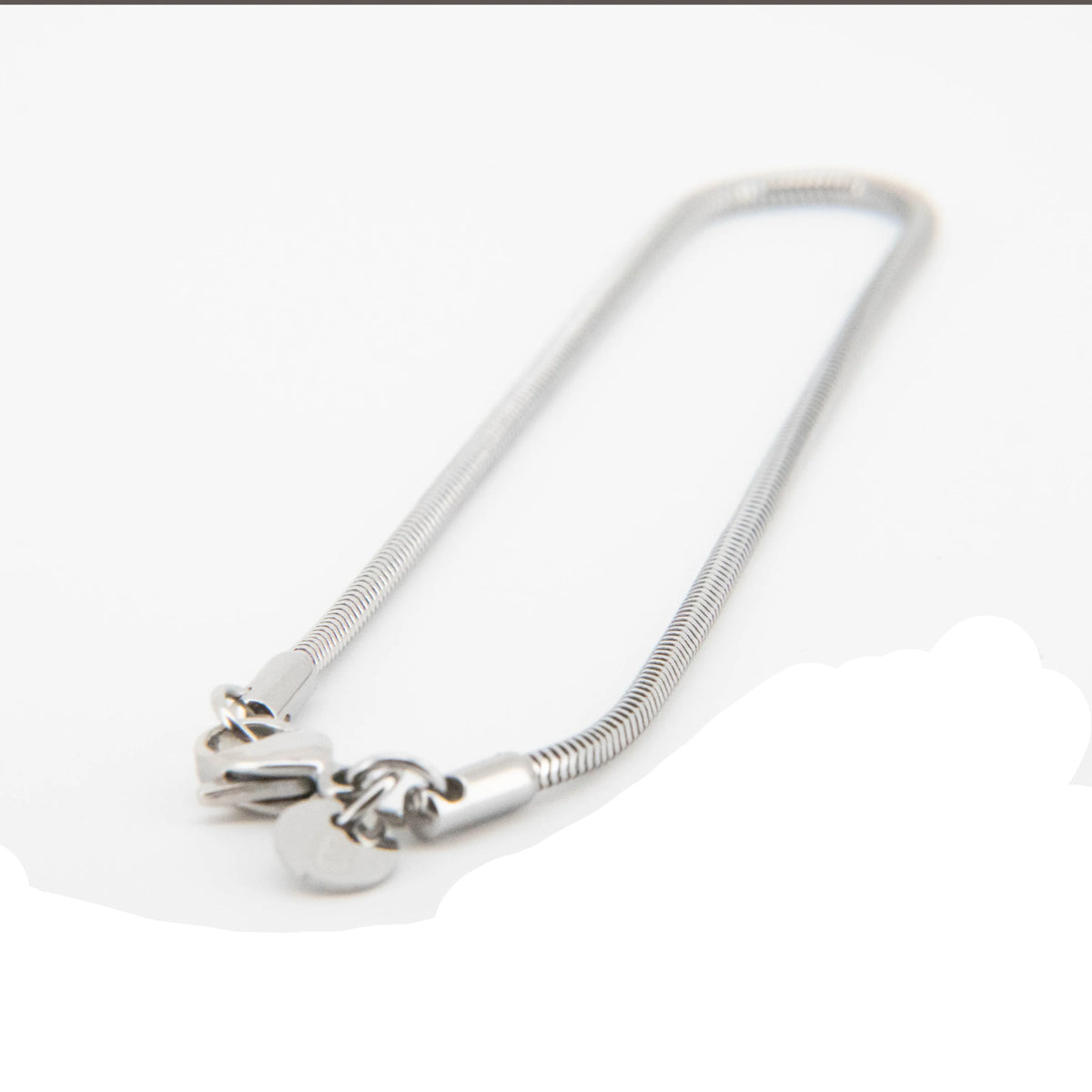 Silver snake chain necklace with decorative end clasps.