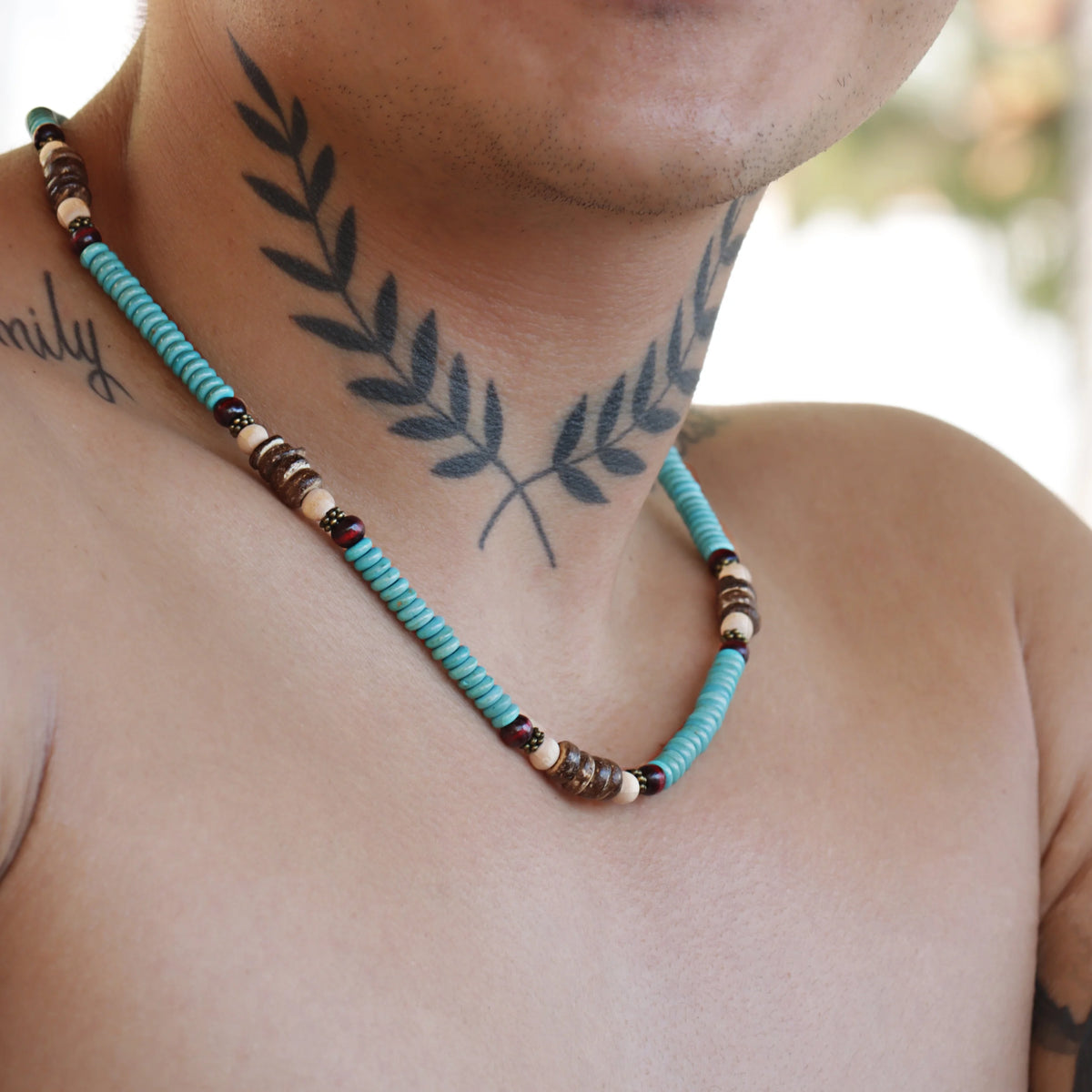 Turquoise and brown beaded necklace with alternating patterns.