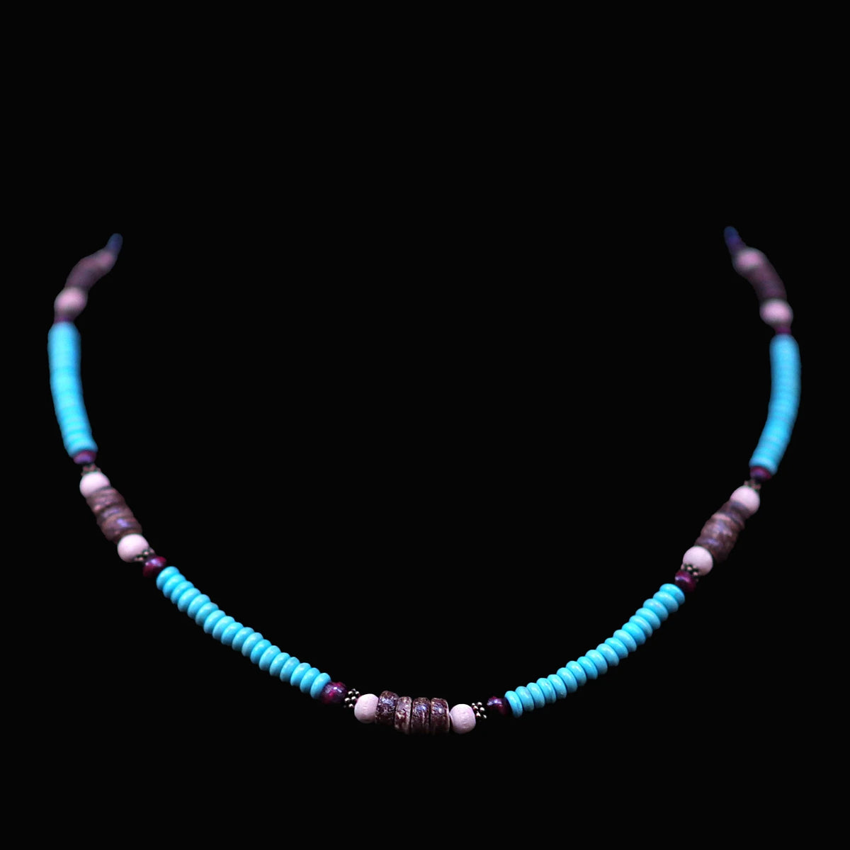 Turquoise and purple beaded necklace with curved tubular sections.