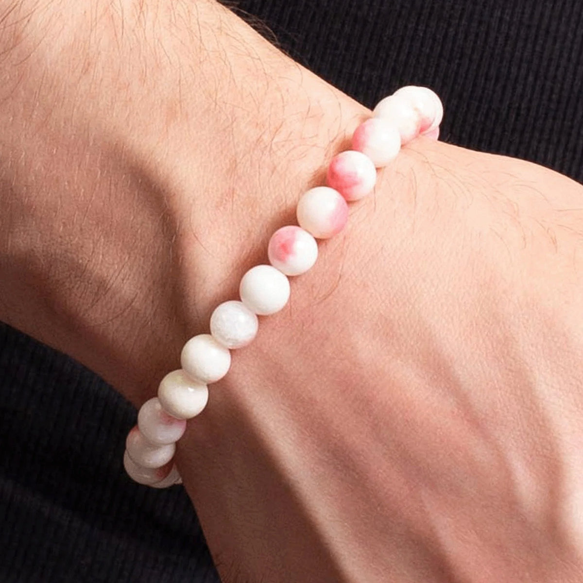 White beaded bracelet worn on a wrist.