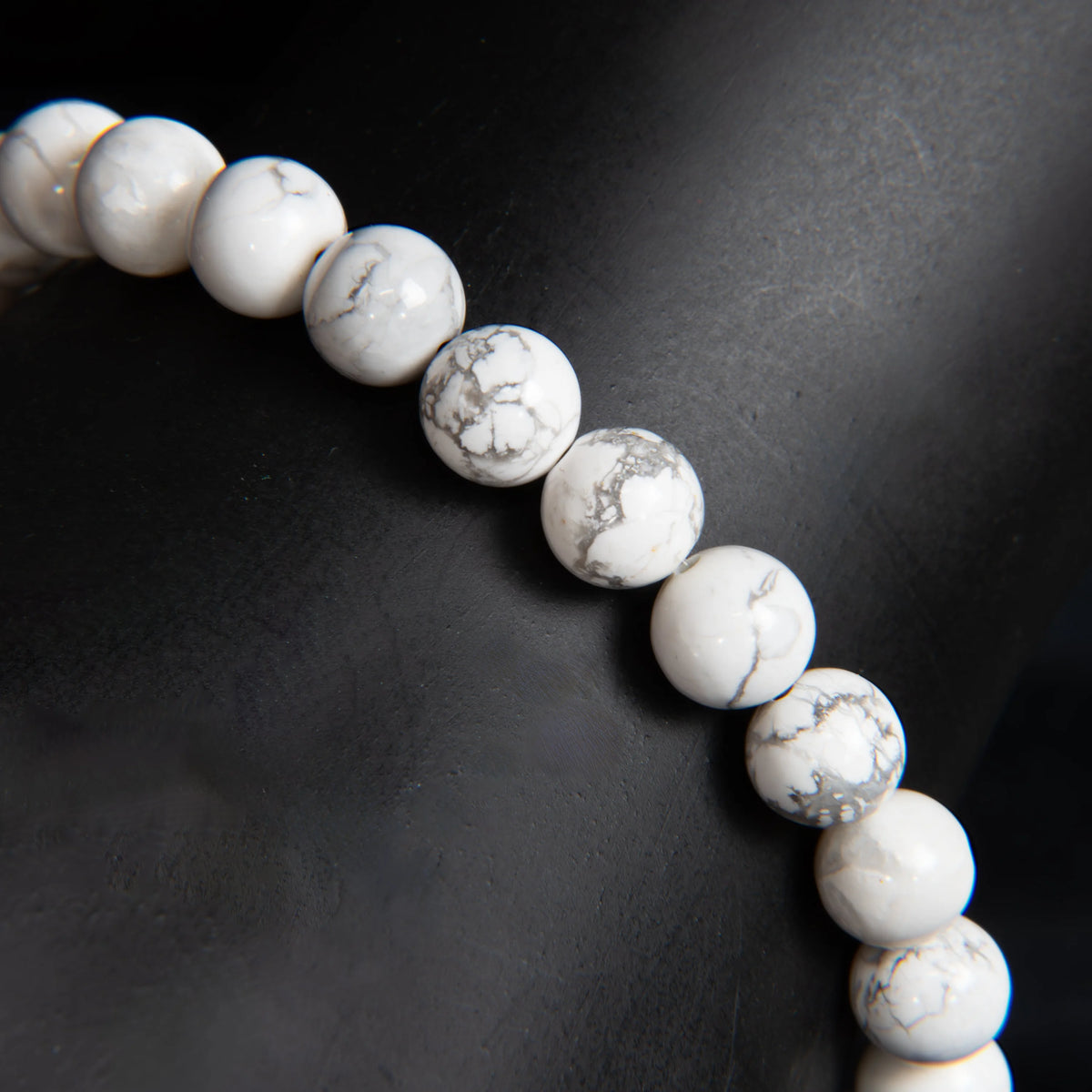 String of white howlite beads with gray veining.