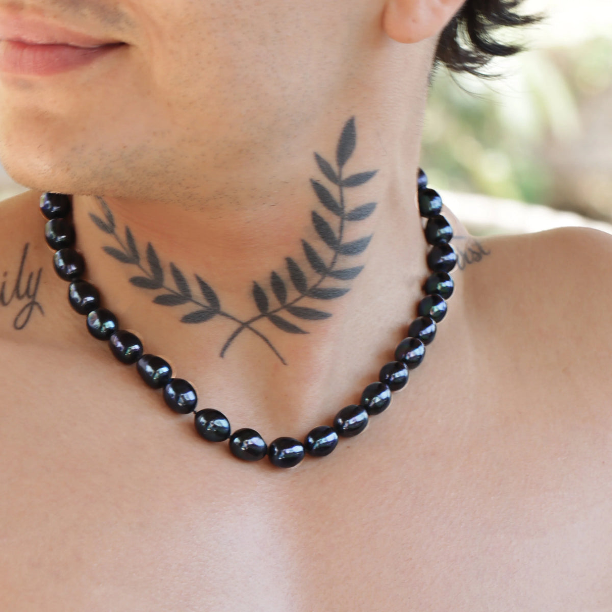 Black pearl necklace with round beads.