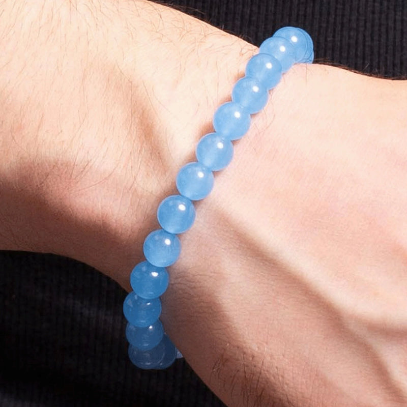 Light blue beaded bracelet worn on a wrist.