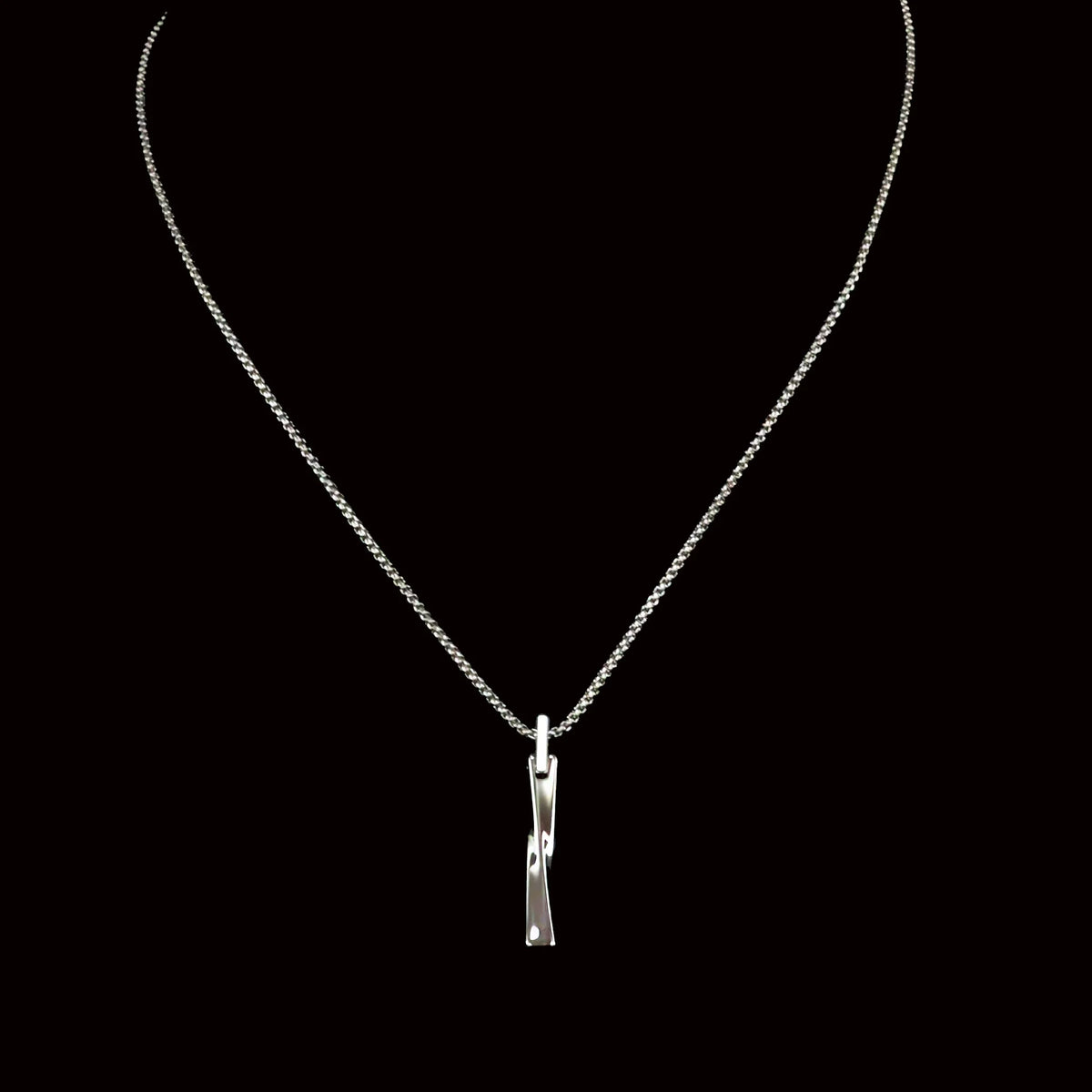 Silver necklace with a twisted bar pendant.