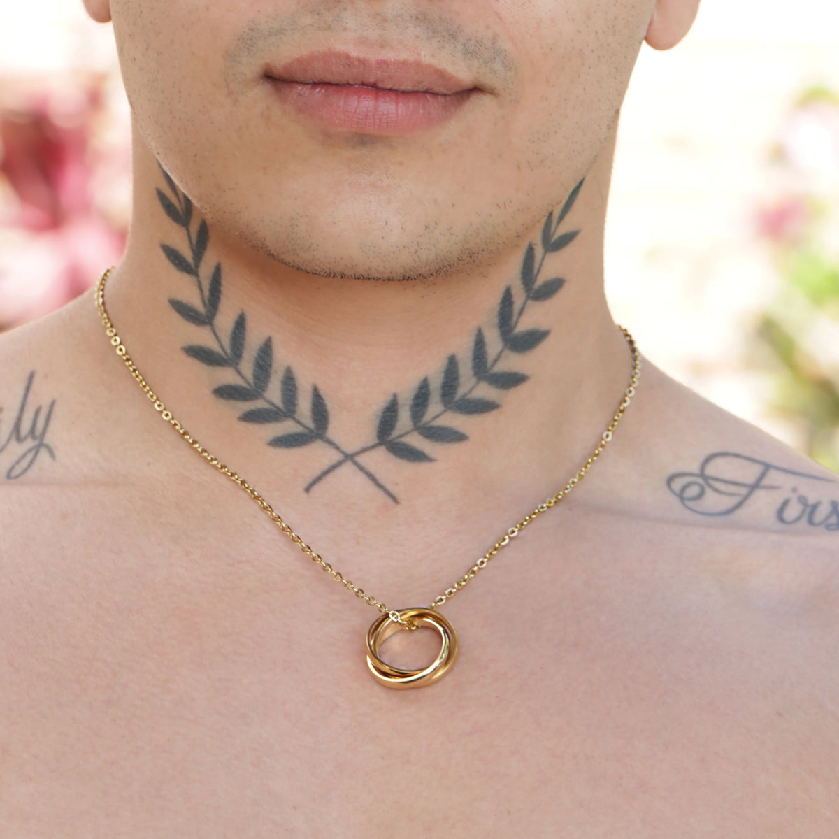 Gold-toned chain necklace with a circular pendant.