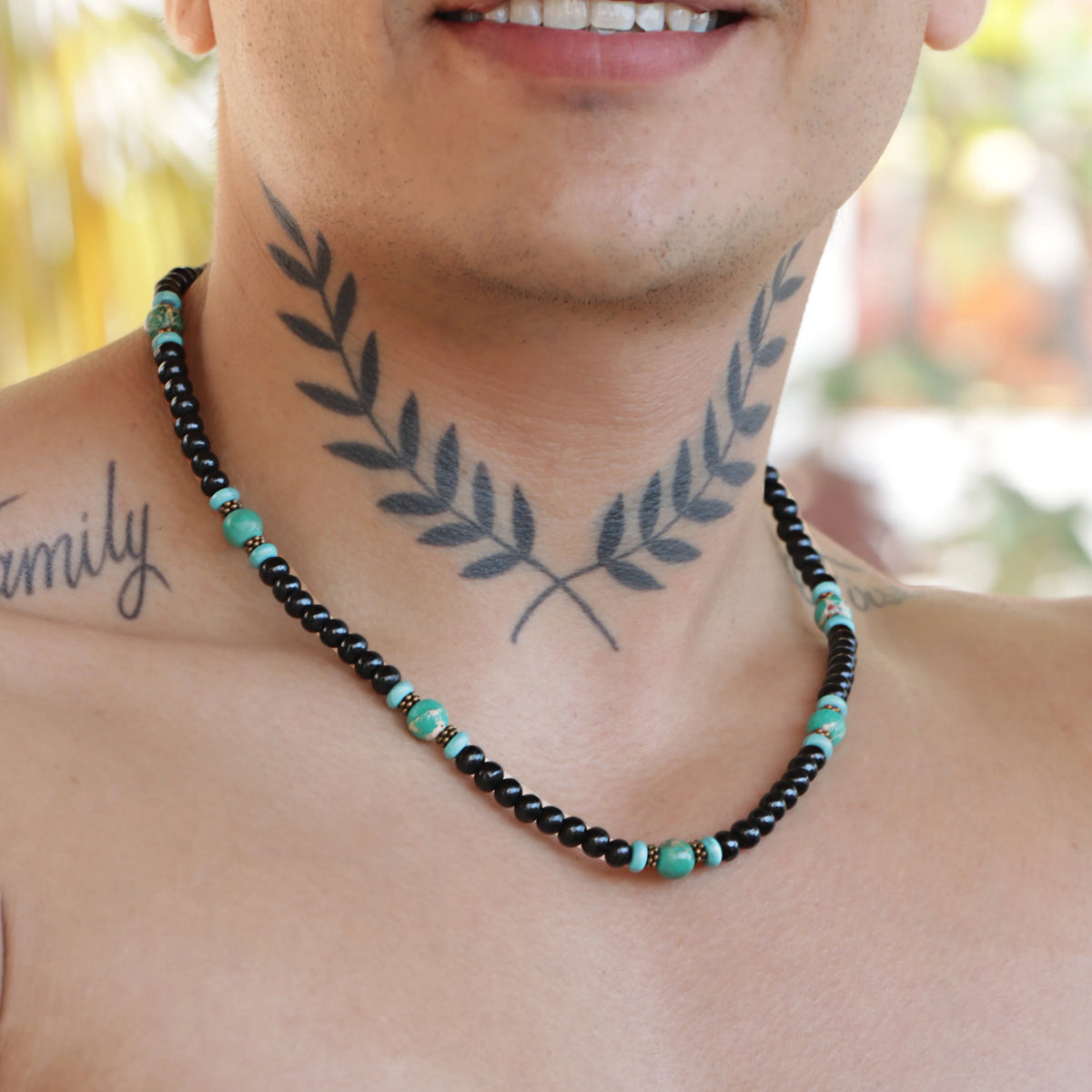 Black beaded necklace with turquoise accents.