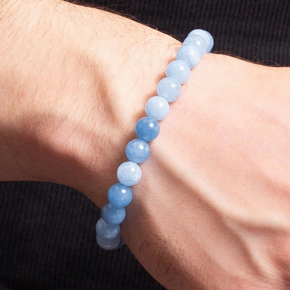 Light blue beaded bracelet worn on a wrist.