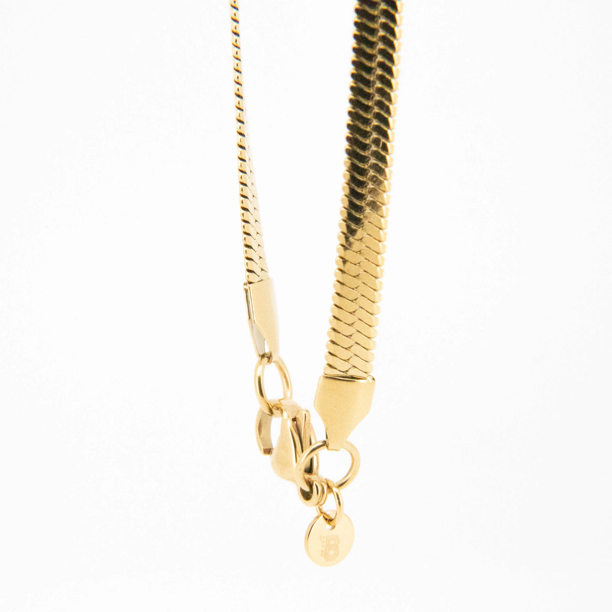 Gold snake chain necklace with a clasp.