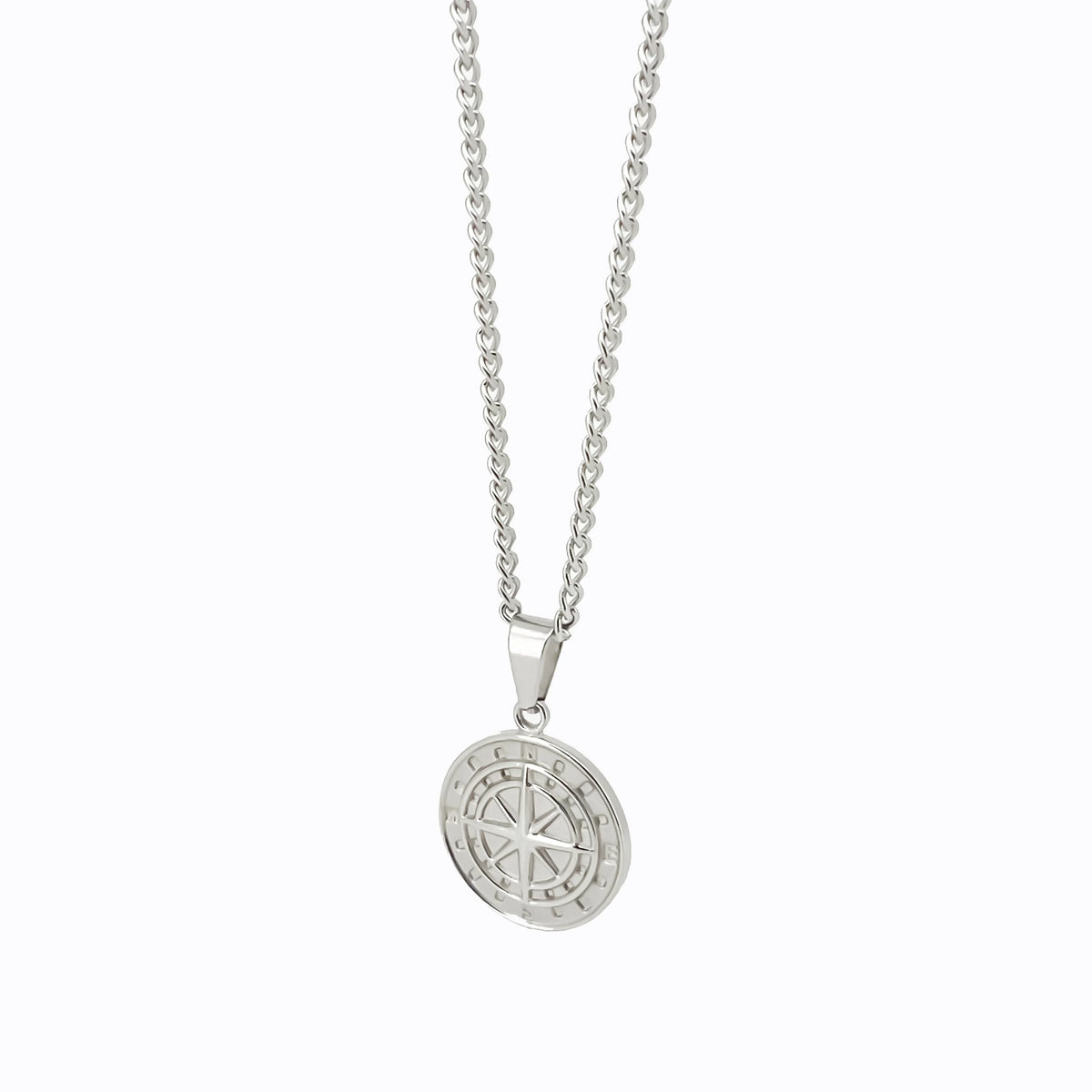 Silver pendant necklace featuring a circular medallion with an engraved compass design.