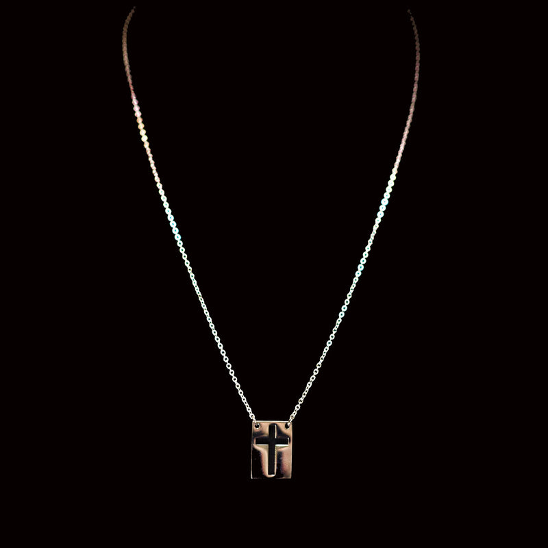 Silver necklace with a cross-shaped pendant.