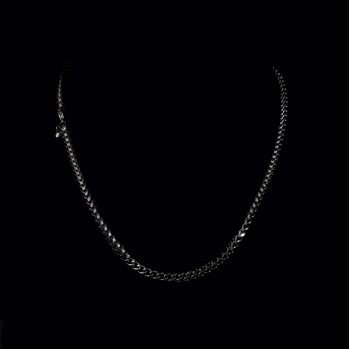 Silver chain necklace with interlocking links.