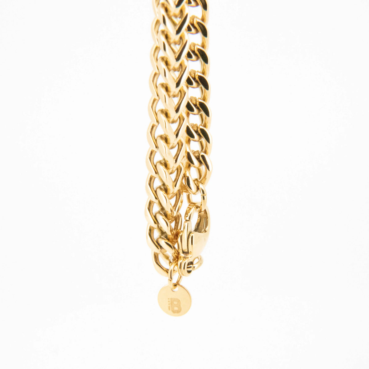 Gold chain bracelet with interwoven links.