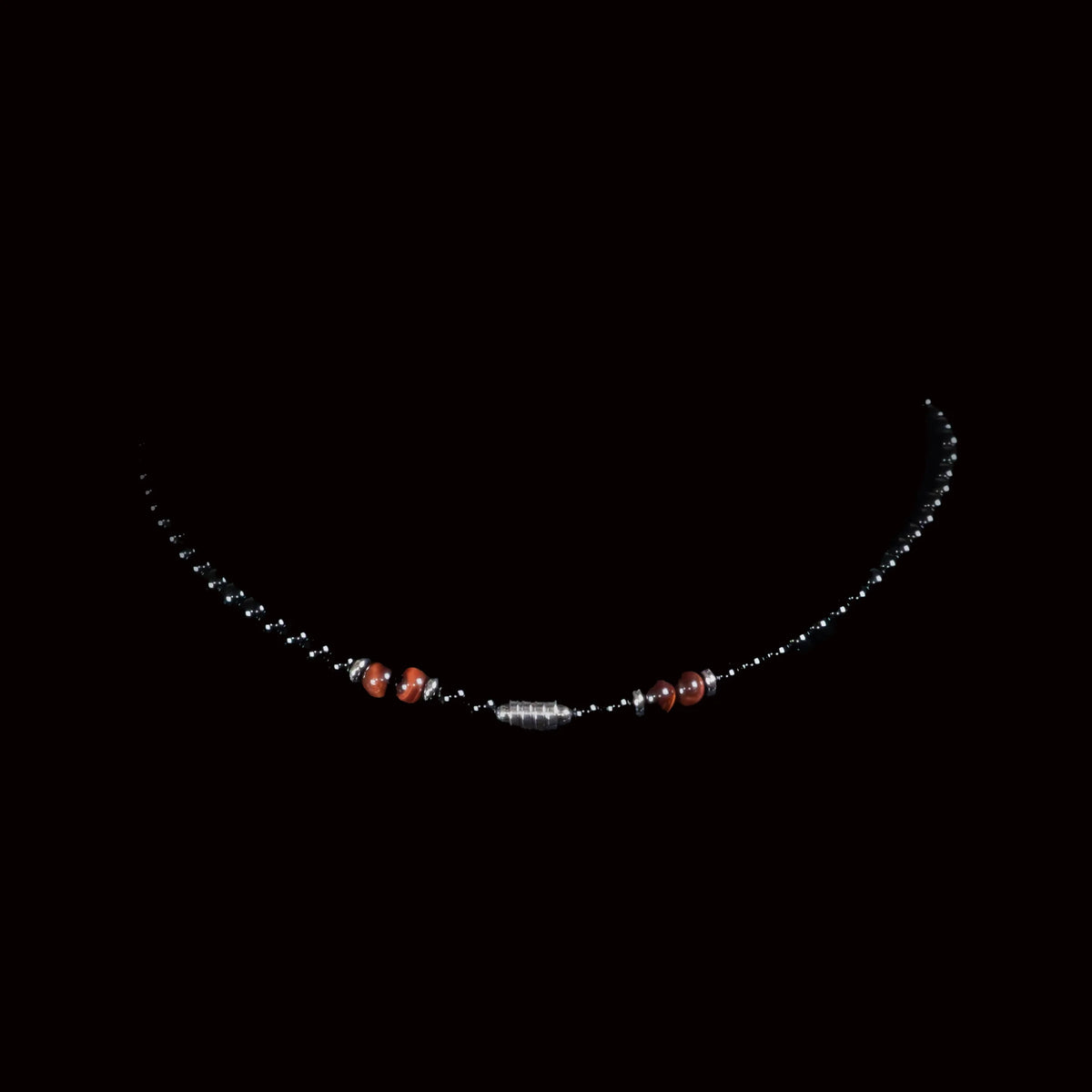 Delicate necklace with small beads and a central silver segment.