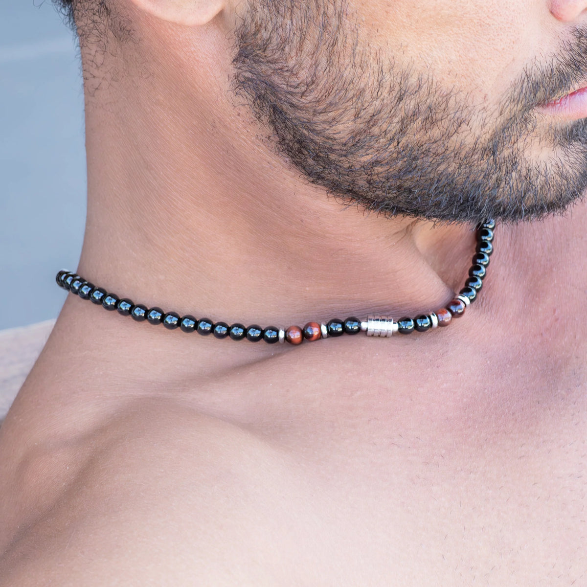 Beaded necklace or choker worn close to the neck.