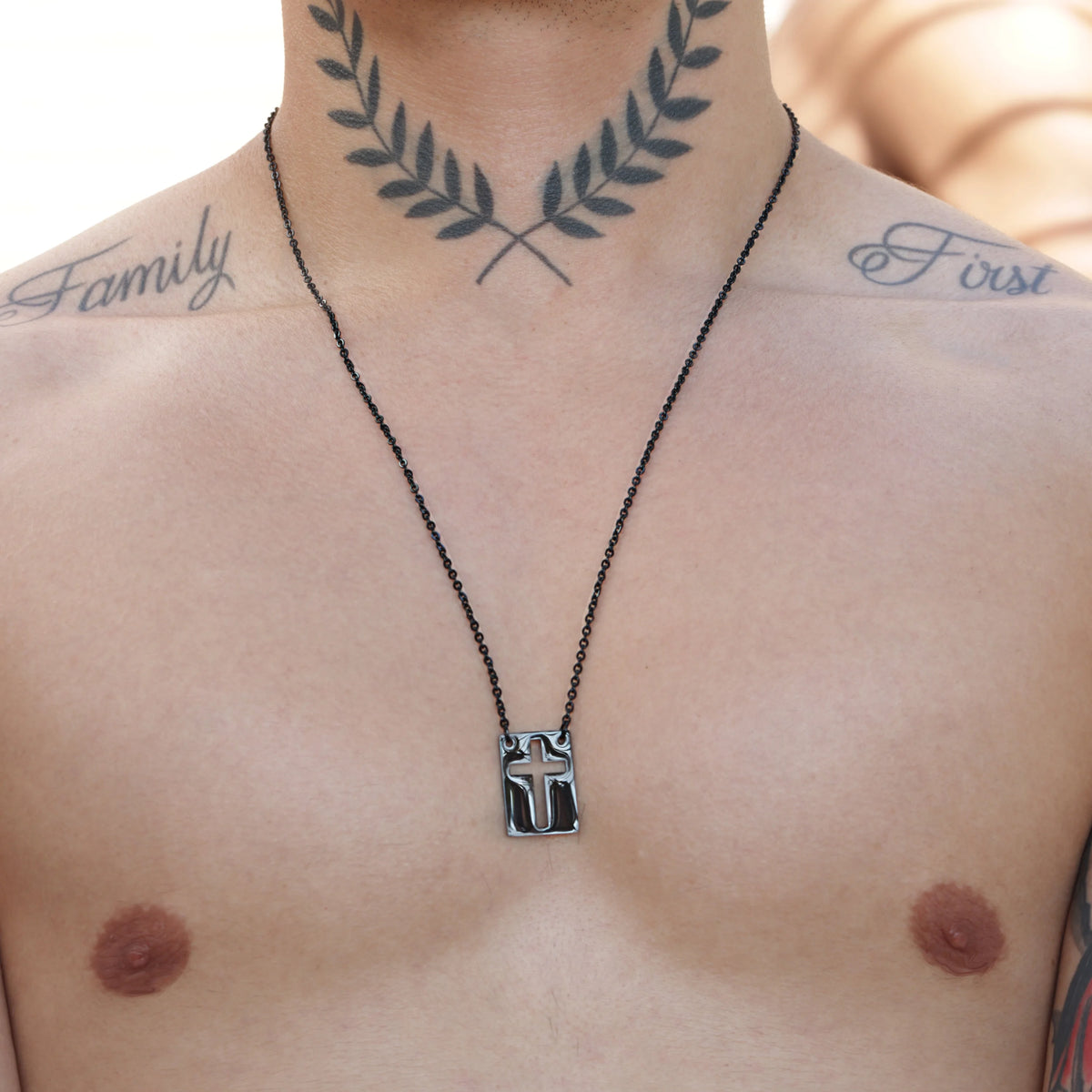 A black chain necklace with a Mandalorian helmet pendant.