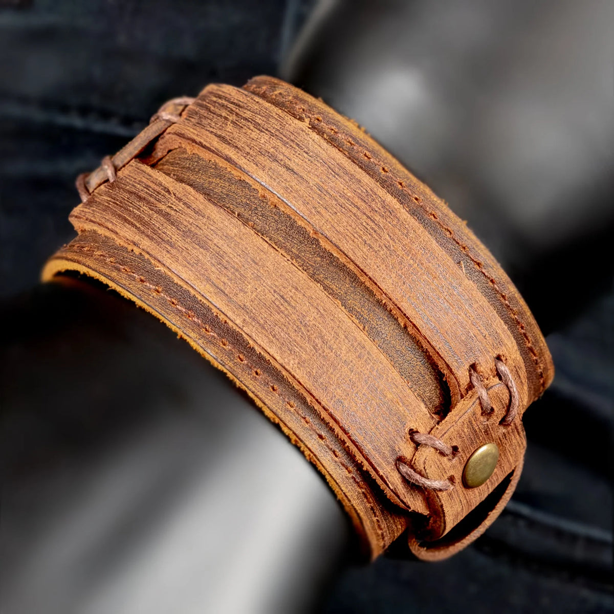 Layered leather cuff bracelet with a brass stud closure.