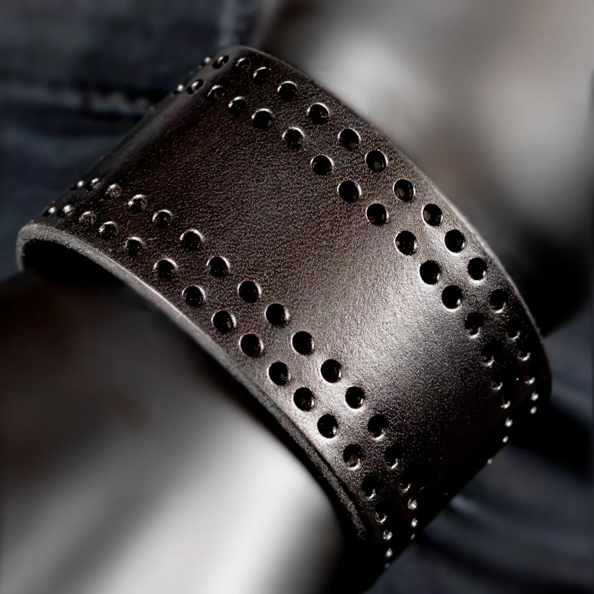 Leather cuff bracelet with perforated design.