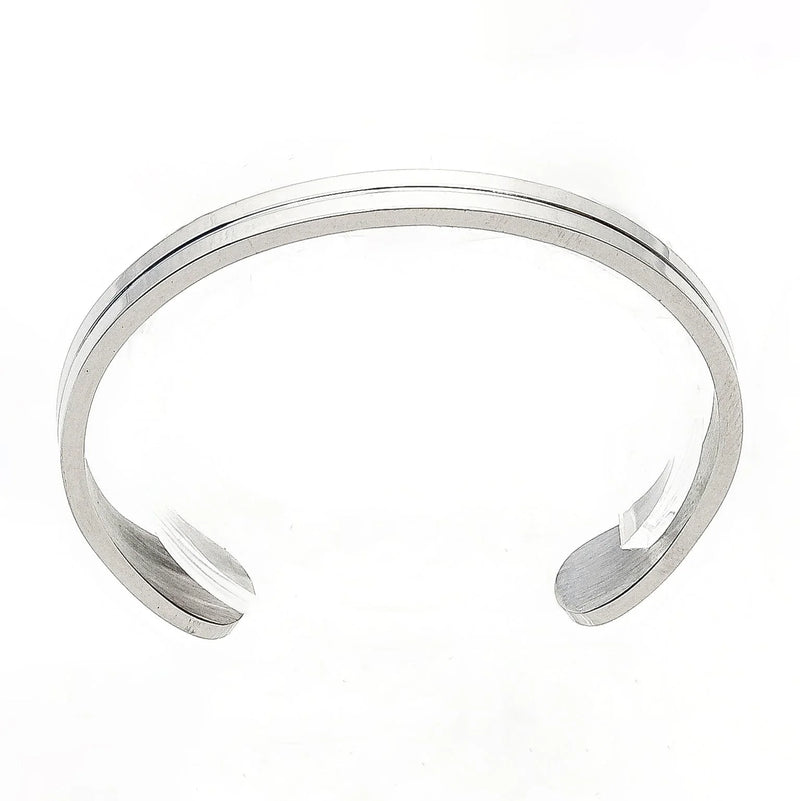 Silver cuff bracelet with a simple, sleek design featuring two parallel grooves.