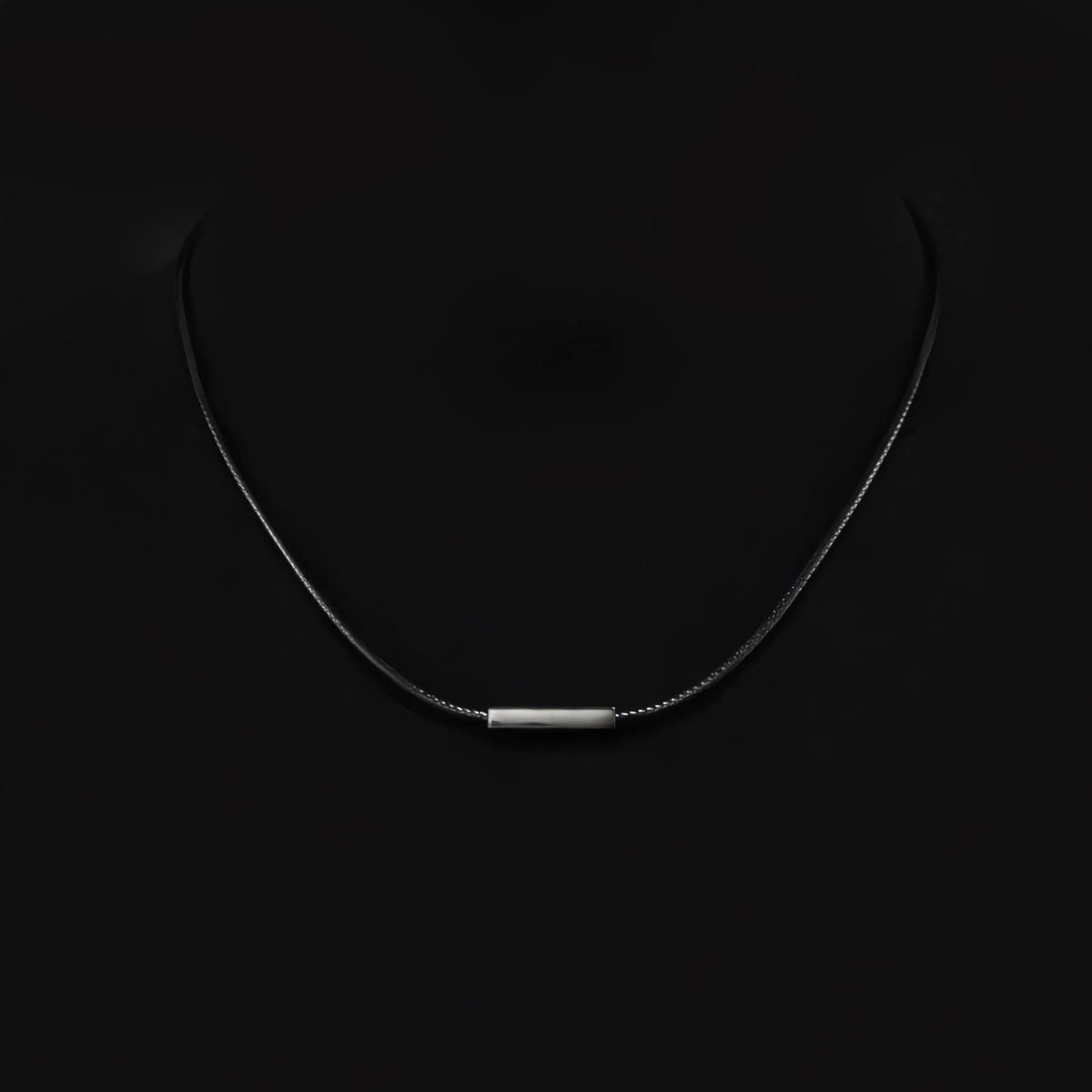 Minimalist silver necklace with a thin horizontal bar pendant on a delicate chain.