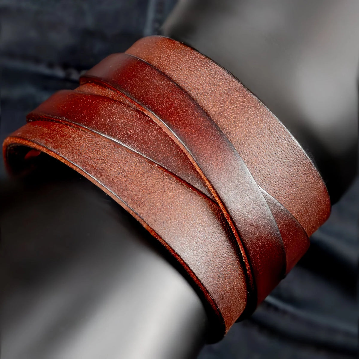 Layered brown leather cuff bracelet with multiple straps.