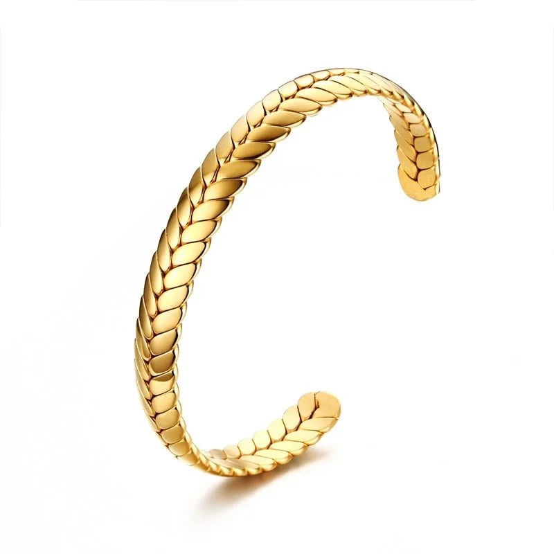 Gold bracelet with a braided wheat or leaf pattern design.