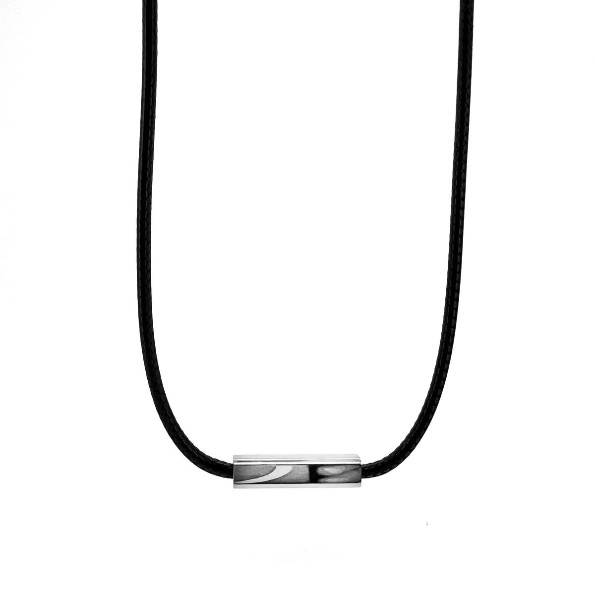 Necklace with a black cord and a small metallic cylindrical pendant.