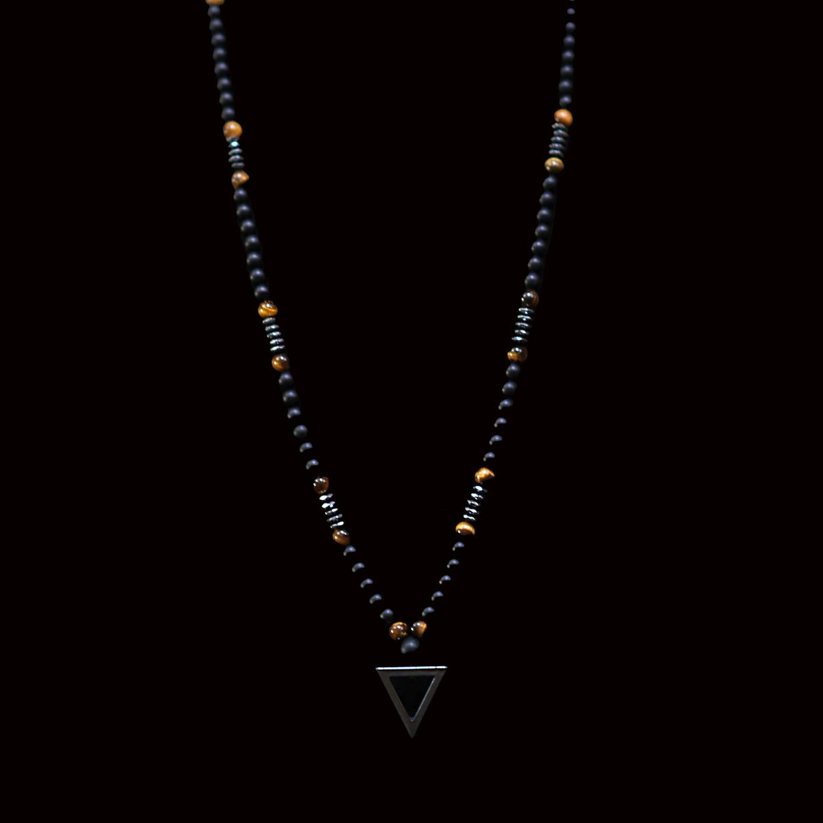 Beaded necklace with a triangular pendant.