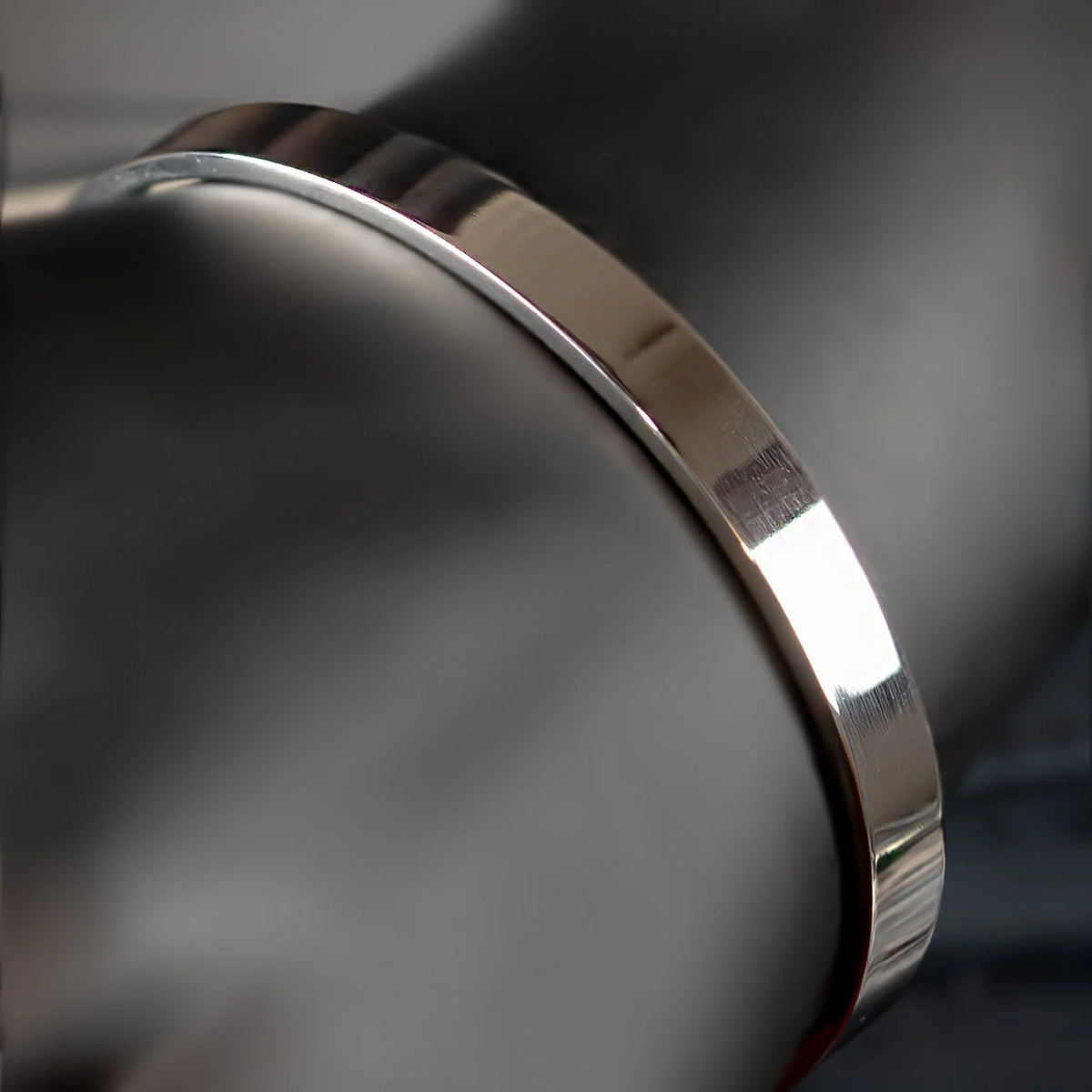 Shiny metallic ring or band with a polished, reflective surface.